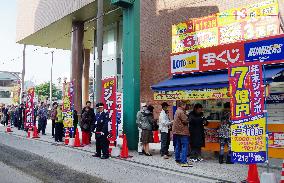 People queue to buy lottery tickets at 'lucky' booth