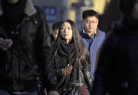 Woman walks during morning commute on Beijing street