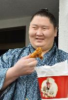 Young sumo wrestler Ichinojo poses with fried chicken
