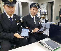 Shinkansen bullet train crew carries iPads