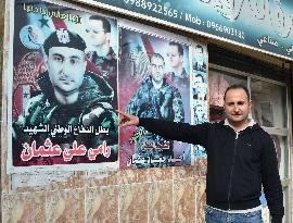 Syrian man points to brother's photo in Tartus