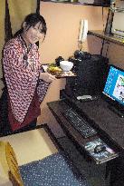 Waitress brings meal at Internet cafe in Akihabara