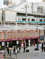 People walk by AKB48 mall under Akihabara Station