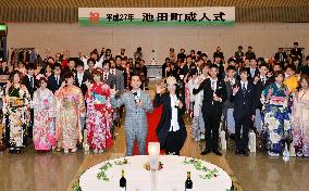 Pop group duo poses with new adults at Hokkaido ceremony