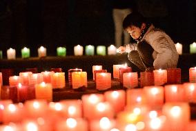 Child lights candle on 20th Hanshin quake anniv.