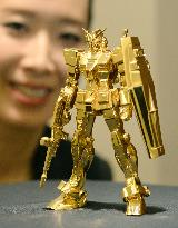 Solid gold Gundam figurine on display in Osaka