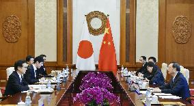 Japanese PM's aide meets China's top diplomat over summit