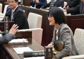 Assembly member brings baby to session