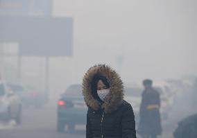 Woman wears mask in air-polluted Mongolian capital