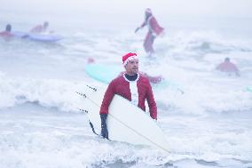 THE NETHERLANDS-THE HAGUE-SURFING SANTAS