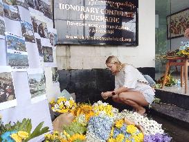 Woman in Bali offers flower for Ukraine