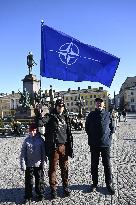 People celebrating the Nato membership of Finland