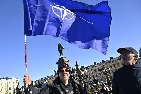 People celebrating the Nato membership of Finland