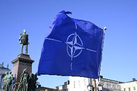 People celebrating the Nato membership of Finland