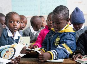 KENYA-NAIROBI-MATHARE SLUM-SCHOOL-BOOK READING