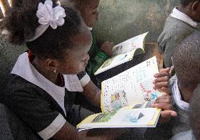 KENYA-NAIROBI-MATHARE SLUM-SCHOOL-BOOK READING