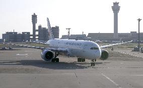 CORRECTED: Plane with evacuees arrives in Tokyo