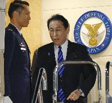 Japan PM returns home
