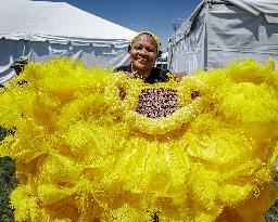 New Orleans Jazz & Heritage Festival Mardi Gras Indian Parade Participants March In Fair Grounds Race Course