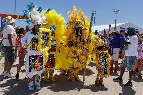 New Orleans Jazz & Heritage Festival Mardi Gras Indian Parade Participants March In Fair Grounds Race Course