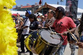 New Orleans Jazz & Heritage Festival Mardi Gras Indian Parade Participants March In Fair Grounds Race Course