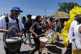 New Orleans Jazz & Heritage Festival Mardi Gras Indian Parade Participants March In Fair Grounds Race Course