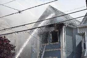 Two Houses Involved In A Multi-Alarm Large Fire In Paterson, New Jersey; Several Victims Including Firefighter Injured