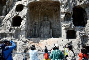 Tourists Visit The Longmen Grottoes in Luoyang