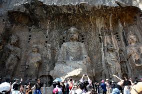 Tourists Visit The Longmen Grottoes in Luoyang