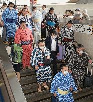 Sumo wrestlers taking bullet train