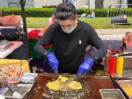 Man Prepares A Snack Consisting Of Corn Kernels With Melted Cheese