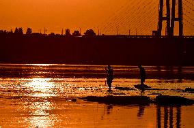 Sunset fishing on shallow Dnipro river