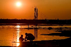 Sunset fishing on shallow Dnipro river