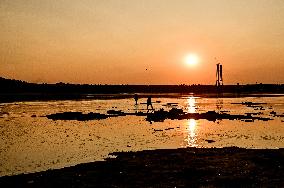 Sunset fishing on shallow Dnipro river