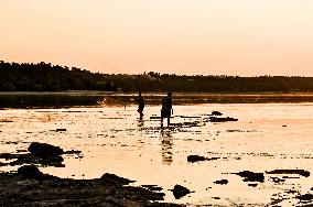 Sunset fishing on shallow Dnipro river