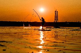 Sunset fishing on shallow Dnipro river