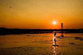 Sunset fishing on shallow Dnipro river