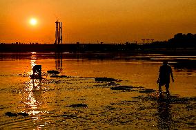 Sunset fishing on shallow Dnipro river
