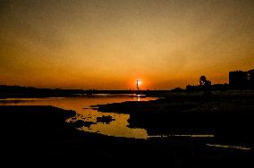 Sunset fishing on shallow Dnipro river