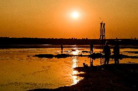 Sunset fishing on shallow Dnipro river