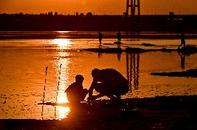 Sunset fishing on shallow Dnipro river