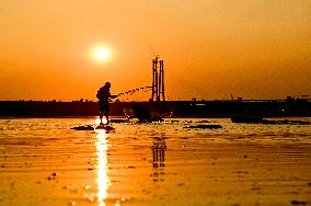 Sunset fishing on shallow Dnipro river