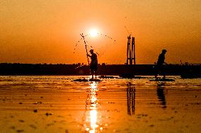 Sunset fishing on shallow Dnipro river