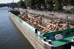 First truss delivered to Notre Dame by a barge cruises along the Seine - Paris