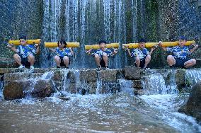 The children Training in Front of The Waterfall