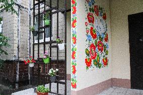 Flowers planted outside residential building bombed by Russians and murals created on walls of surviving blocks In Dnipro
