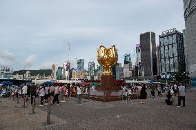 Tourists Visit Golden Bauhinia Square in Hong Kong, China