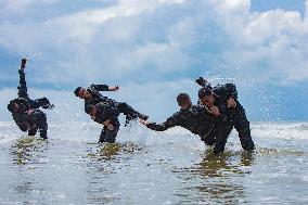 Armed Police Officers Strengthen Training in Seawater in Fangchenggang, China
