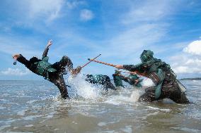 Armed Police Officers Strengthen Training in Seawater in Fangchenggang, China
