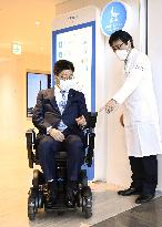 Japan health minister tries robot designed for patients